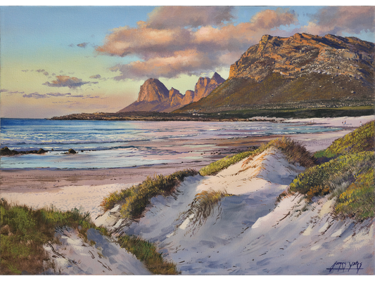 Oil painting of Pringle Bay beach with white sand dunes in the foreground and large, sunlit mountains under a soft cloudy sky.