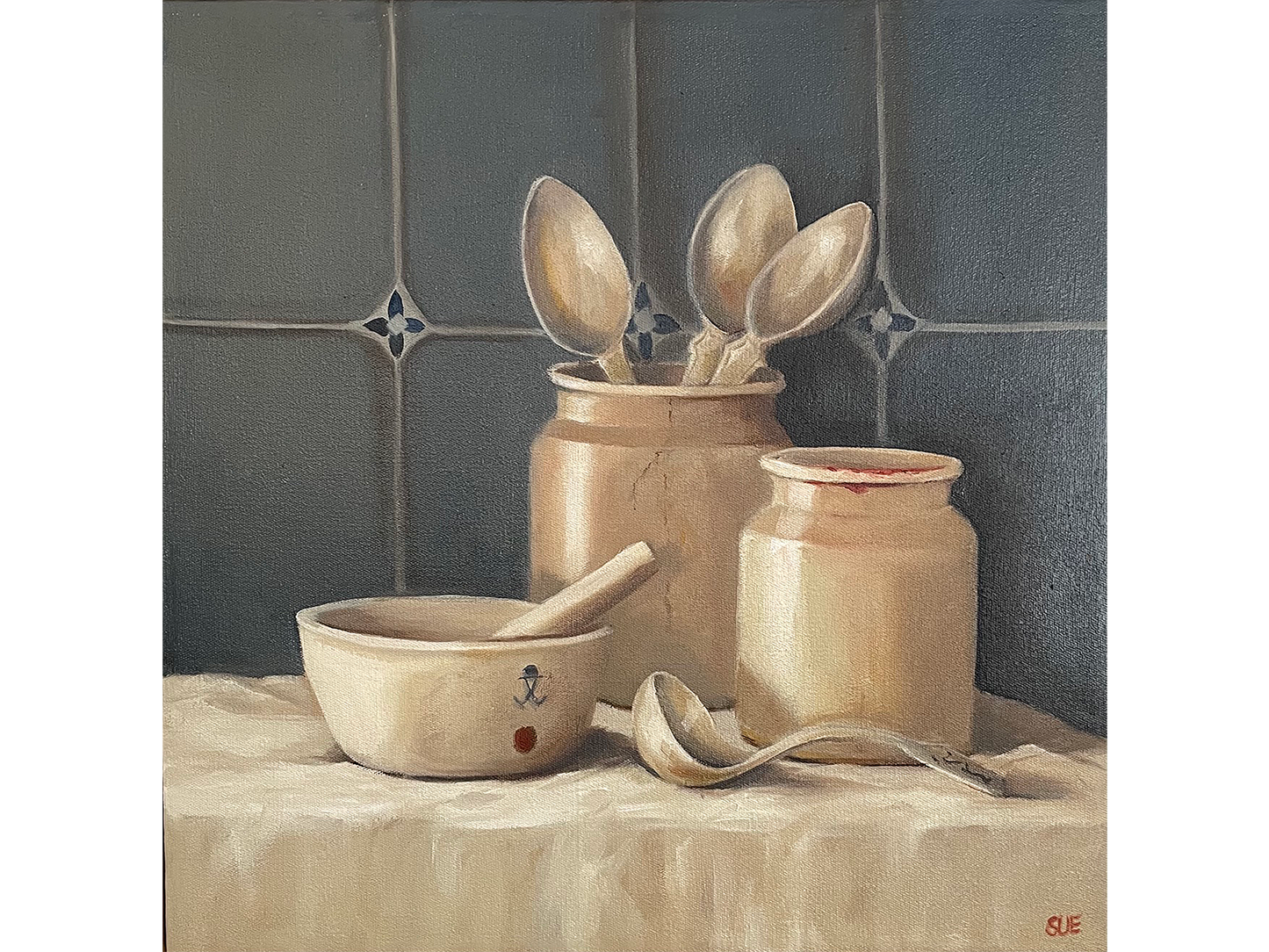 Square oil painting of rustic pottery jars, wooden spoons, a ceramic bowl, and a wooden ladle arranged on a cream cloth against a blue tiled backdrop.